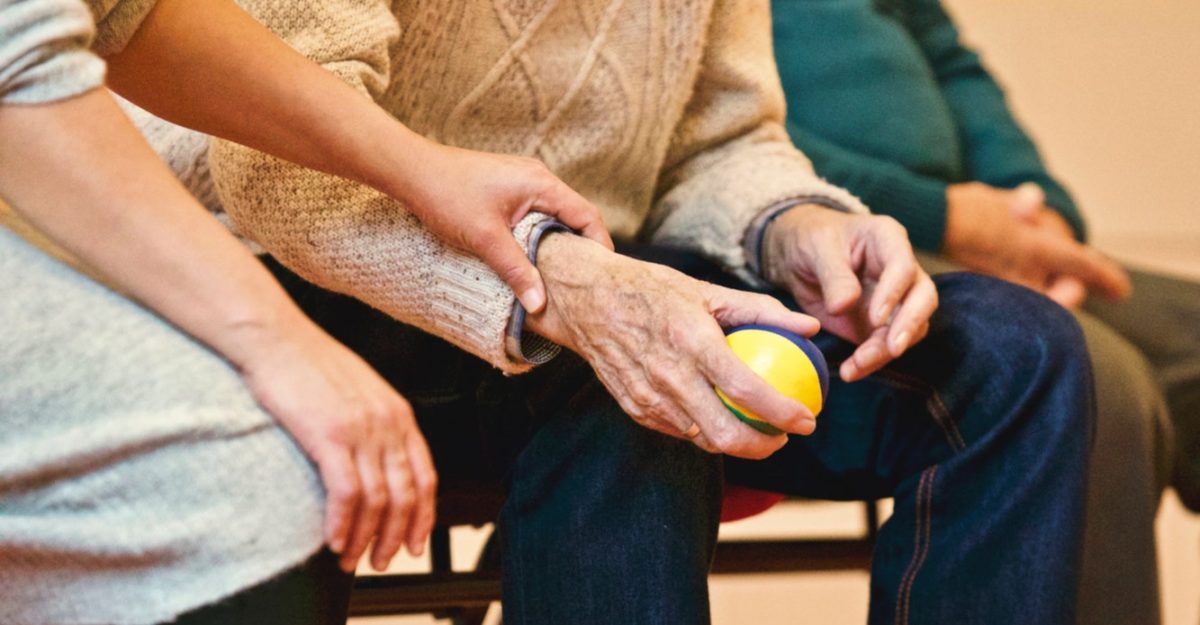 Hands of Elderly Man and Care Worker