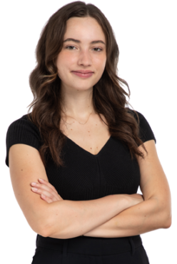 Toronto Paralegal Lauren Reid stands with her arms crossed and a confident smile on her face.