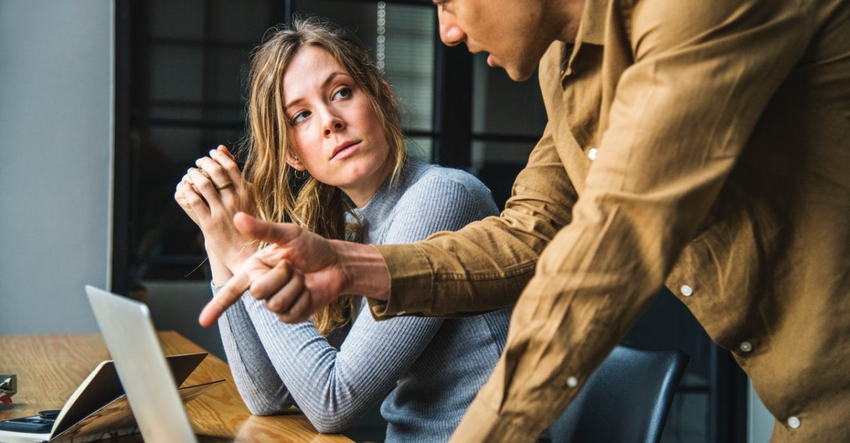 Man and Woman Discuss Over Computer