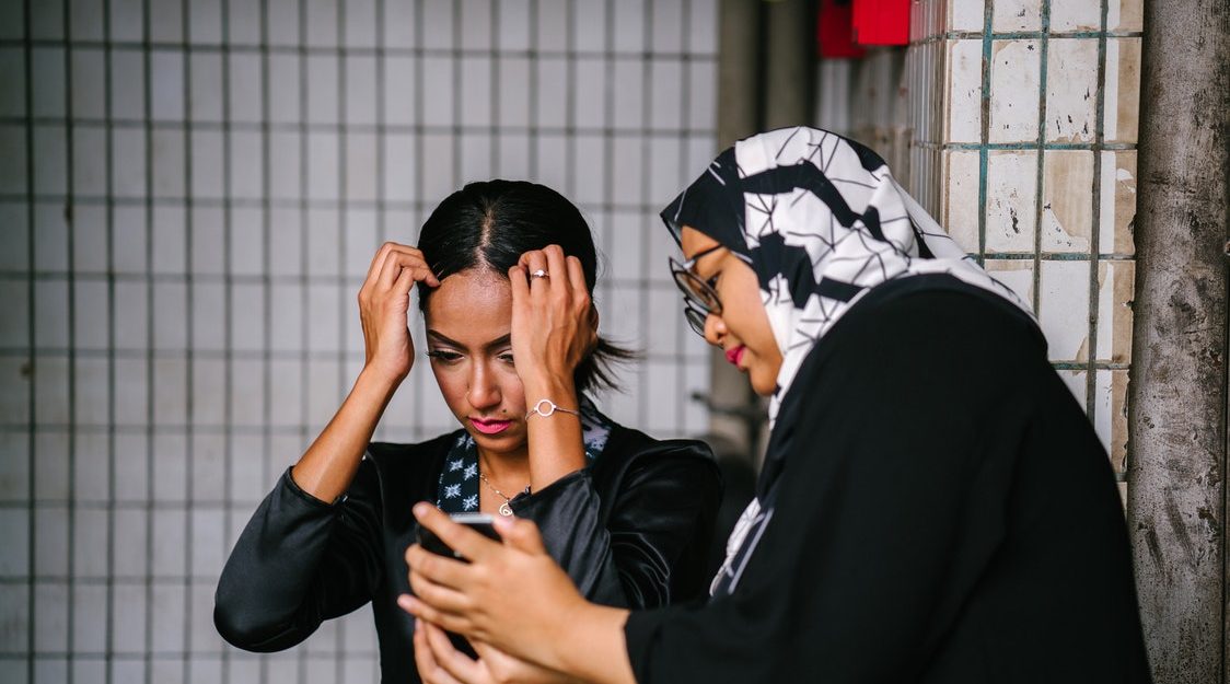 Woman Showing Woman Phone