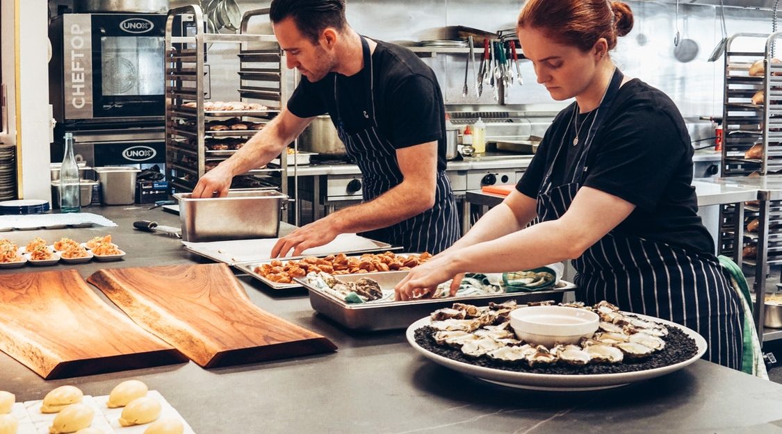 Kitchen Staff Prepare Catering Platters