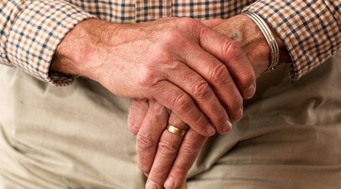 Hands Folded on Cane