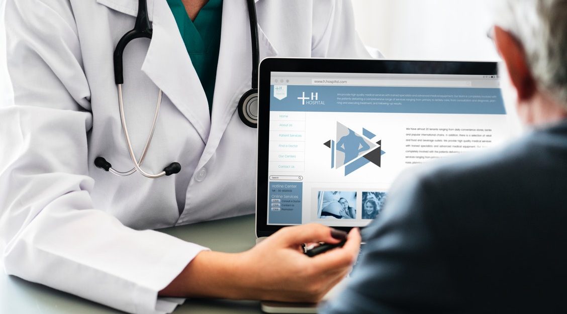 Doctor Showing Results on Screen
