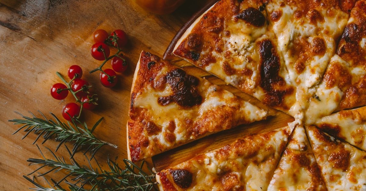 A delicious slice of artisan cheese pizza sits slightly removed from the rest of the pie. Pizza Hut employees are entitled to full severance pay when they lose their job.