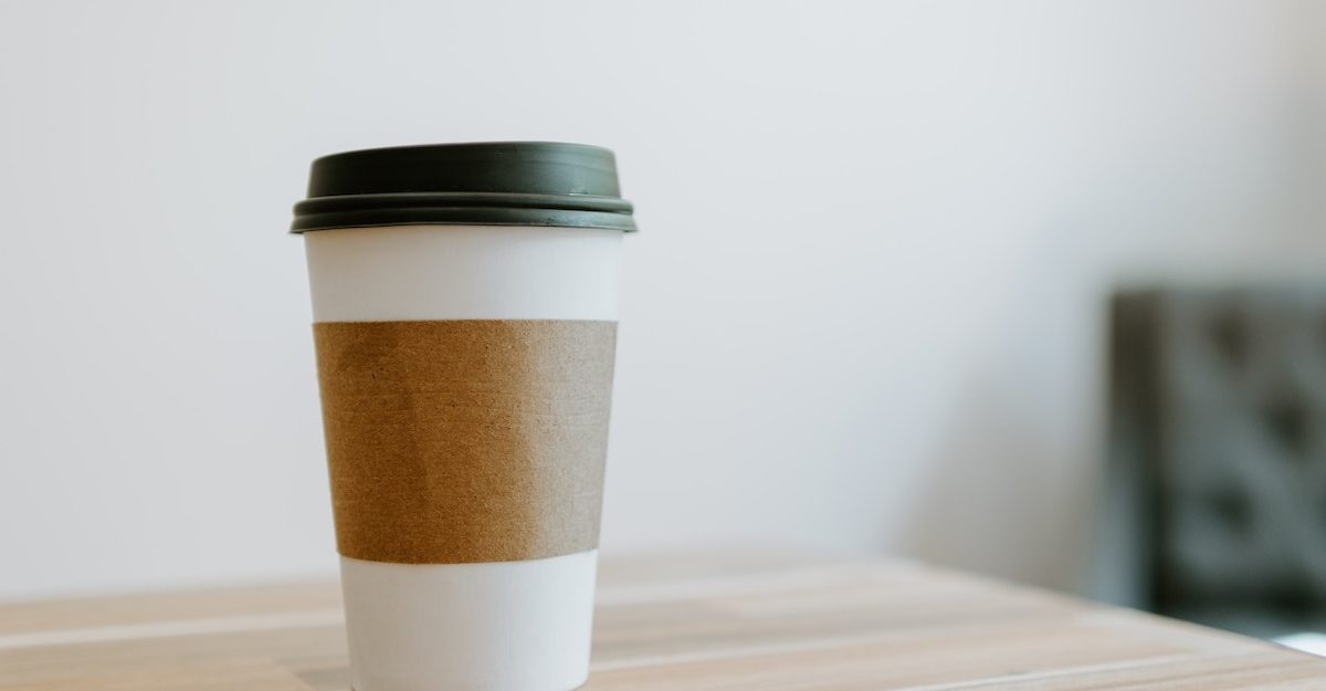 A nondescript cup off coffee from a fast food restaurant sits on a table. Tim Hortons employees are entitled to severance pay when they lose their job.