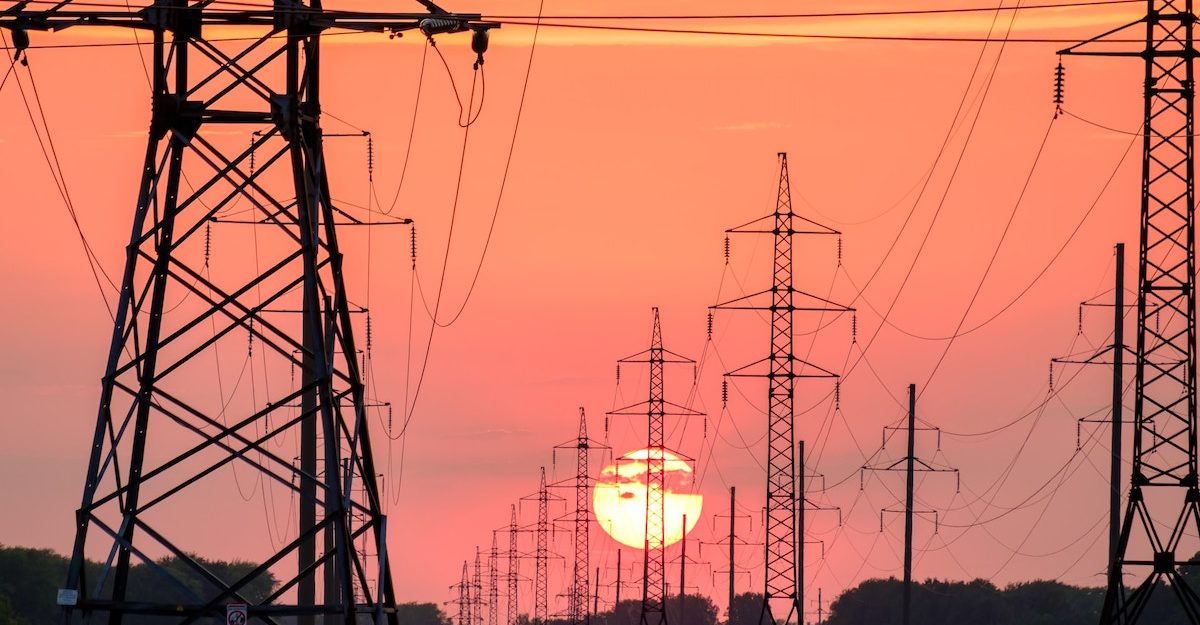 Two columns of electrical transmission towers extend into the distance as the sun sets on the horizon. Ontario Power Generation employees are entitled to severance when they lose their job.