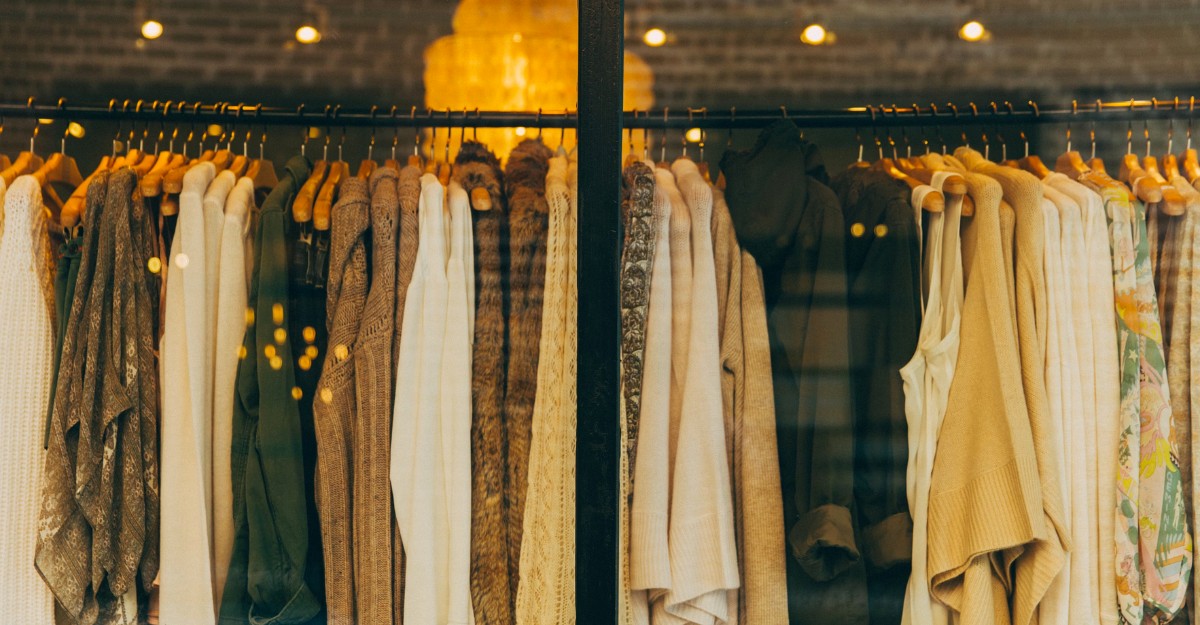 A photo of clothing on a rack in a store. (Phone: Hannah Morgan / Unsplash)