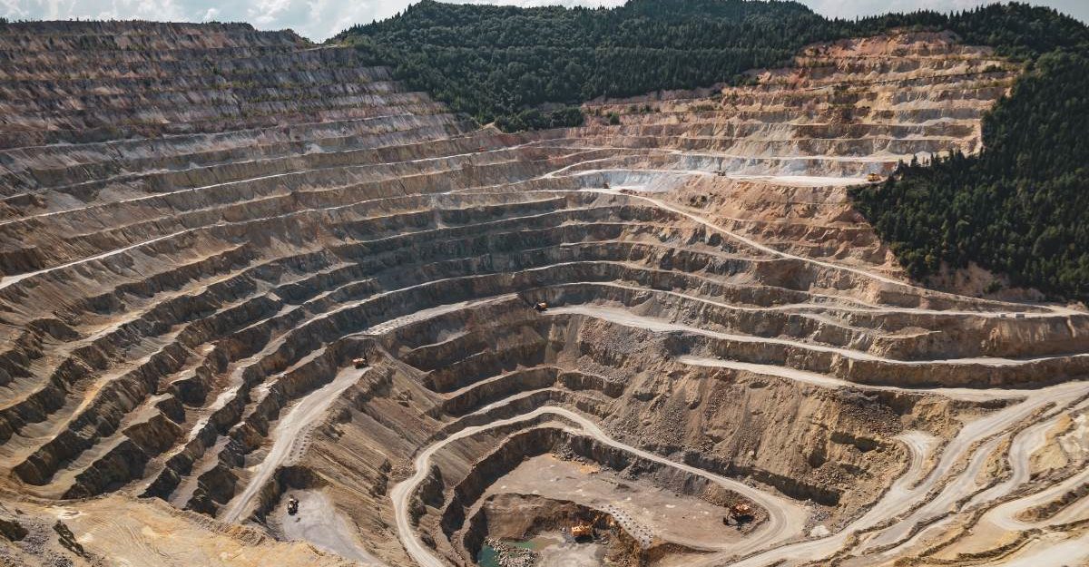 A vast open-pit mine descends deep into the Earth's crust. Lundin Mining employees are entitled to full severance packages.