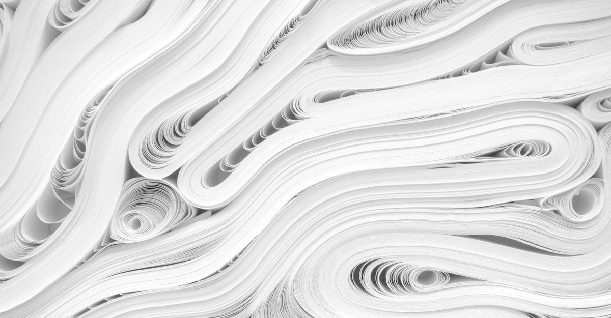 Roles and reams of white paper are smushed and shoved together. Domtar employees are entitled to severance pay when they lose their job.