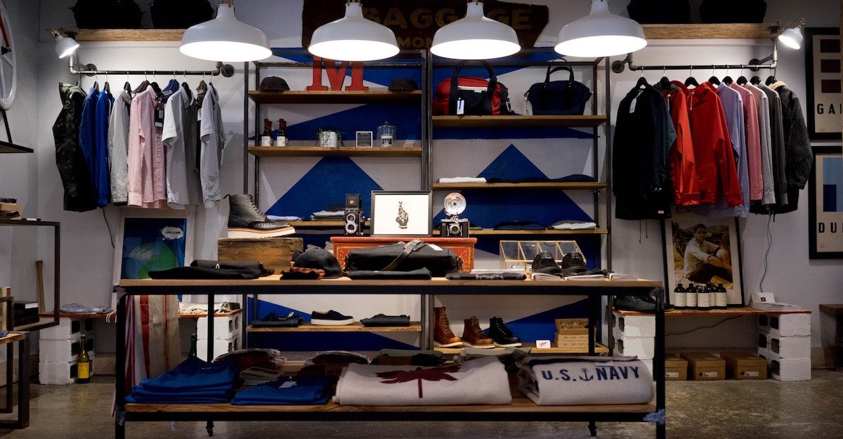 Various articles of clothing are seen in a clothing store. Roots Canada employees are entitled to full severance when they lose their job.