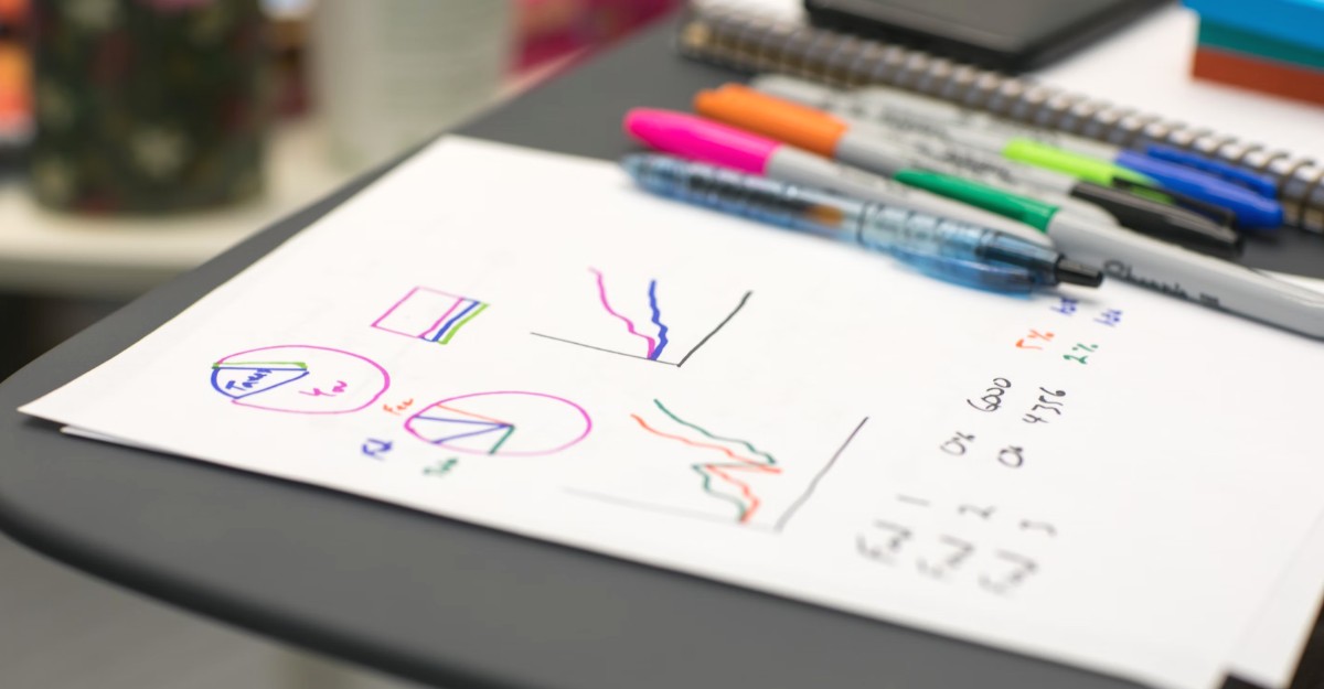 A photo of a piece of paper beside multiple sharpie markers on a desk. (Photo: Jason Coudriet / Unsplash)