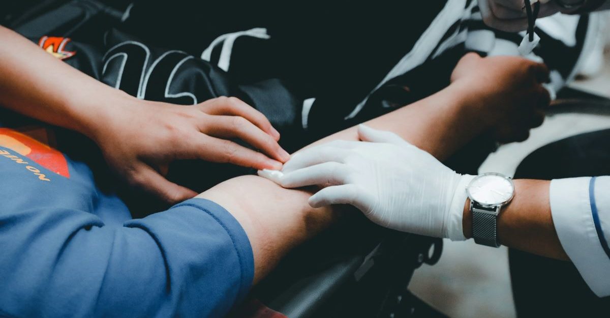 A medical worker draws blood from a donor.