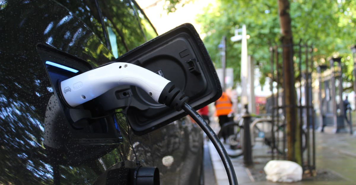 A photo of a charger in a black electric vehicle. (Photo: Andrew Roberts / Unsplash)