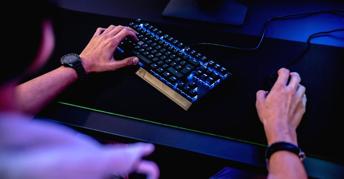 A photo of a person with headphones on using a mouse and keyboard, potentially working for Sumo Group. (Photo: ELLA DON / Unsplash)