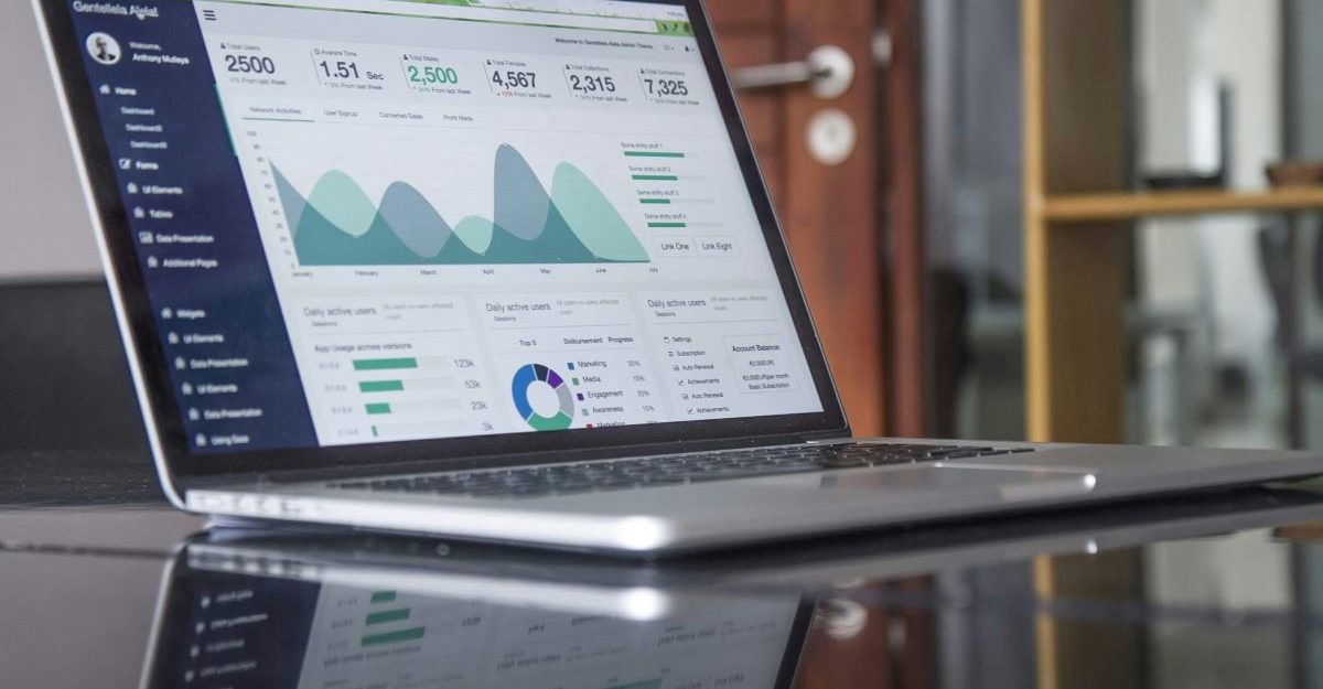 A laptop screen shows financial information, potentially related to TMX Group.