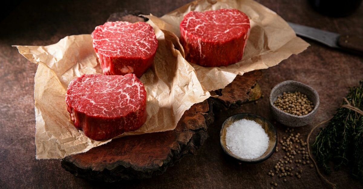 Three delicious cuts of beef sit on brown parchment paper.