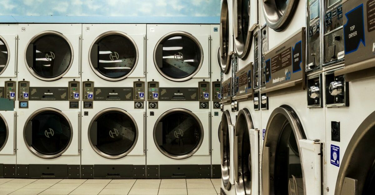 Washing machines and dryers are stacked on top of one another in long rows.