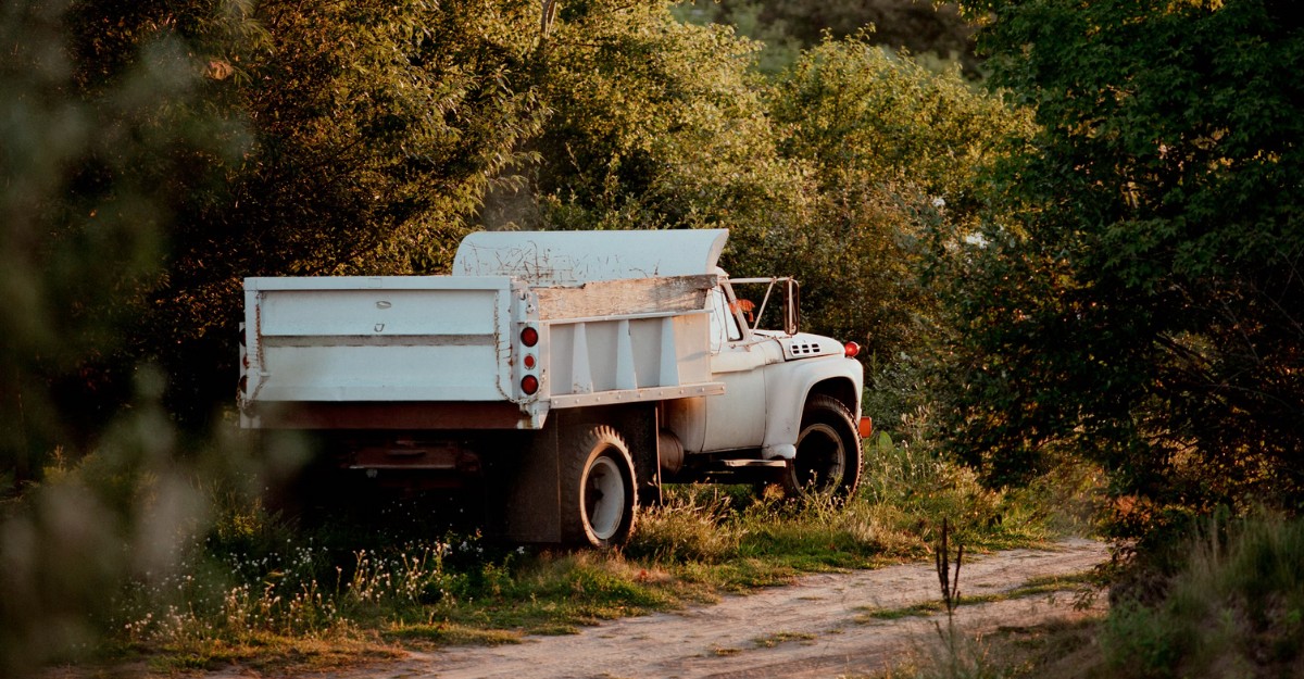 A photo of a truck parked on the side of the road in a wooded area. (Photo: Laura Ohlman / Unsplash)