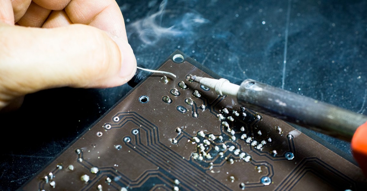 A photo of a person using a soldering iron. (Photo: Blaz Erzetic / Unsplash)