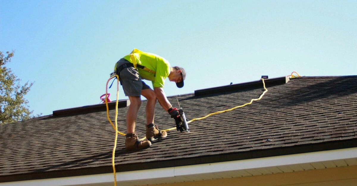 A roofer is hard at work on a client's roof.