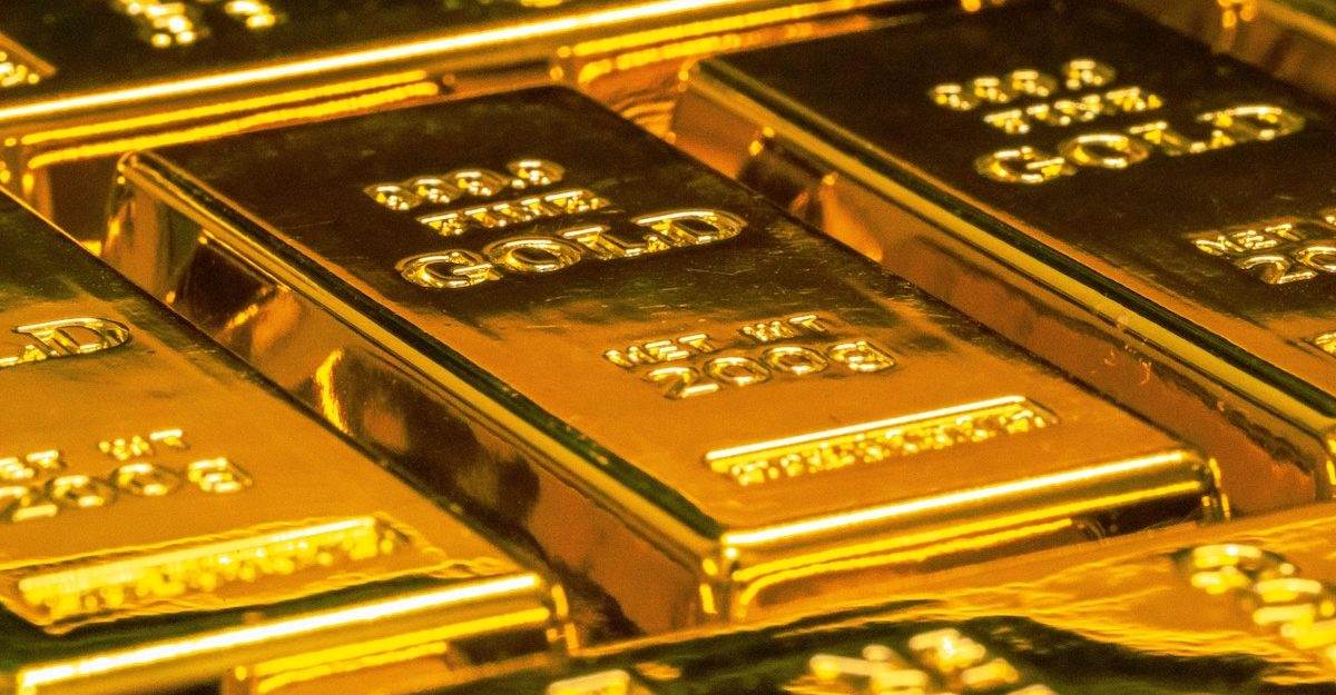 Bars of pure gold are arranged in rows.