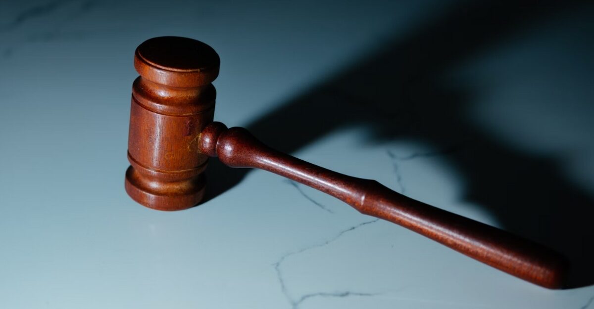A photo of a wooden gavel on a marble table. (Photo: Wesley Tingey / Unsplash)