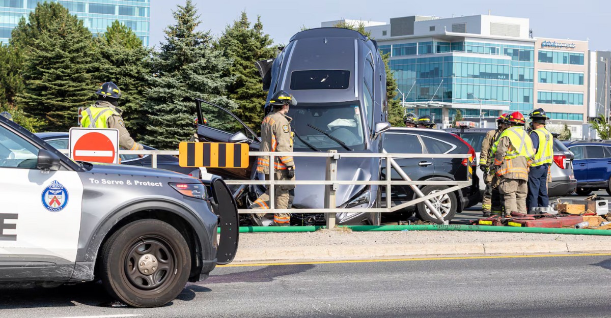 A photo of a grey Lexus on top of another vehicle on Highway 404 near the Woodbine/Steeles off-ramp. (Photo supplied to CTV News Toronto)