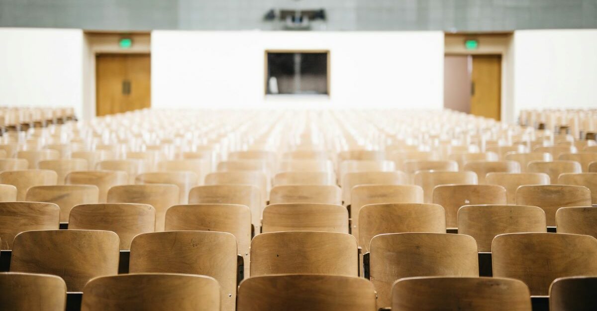 Rows of empty seats in a lecture hall at a university, college, or post secondary institution.