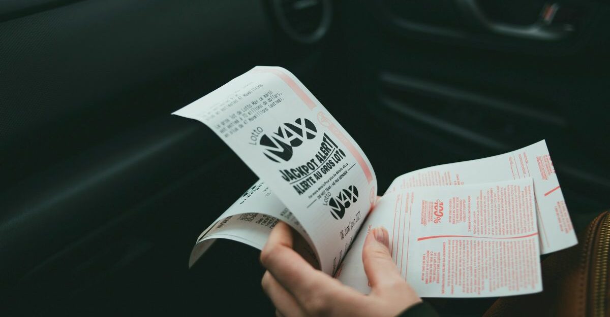 Somebody clutches a handful of lottery tickets.