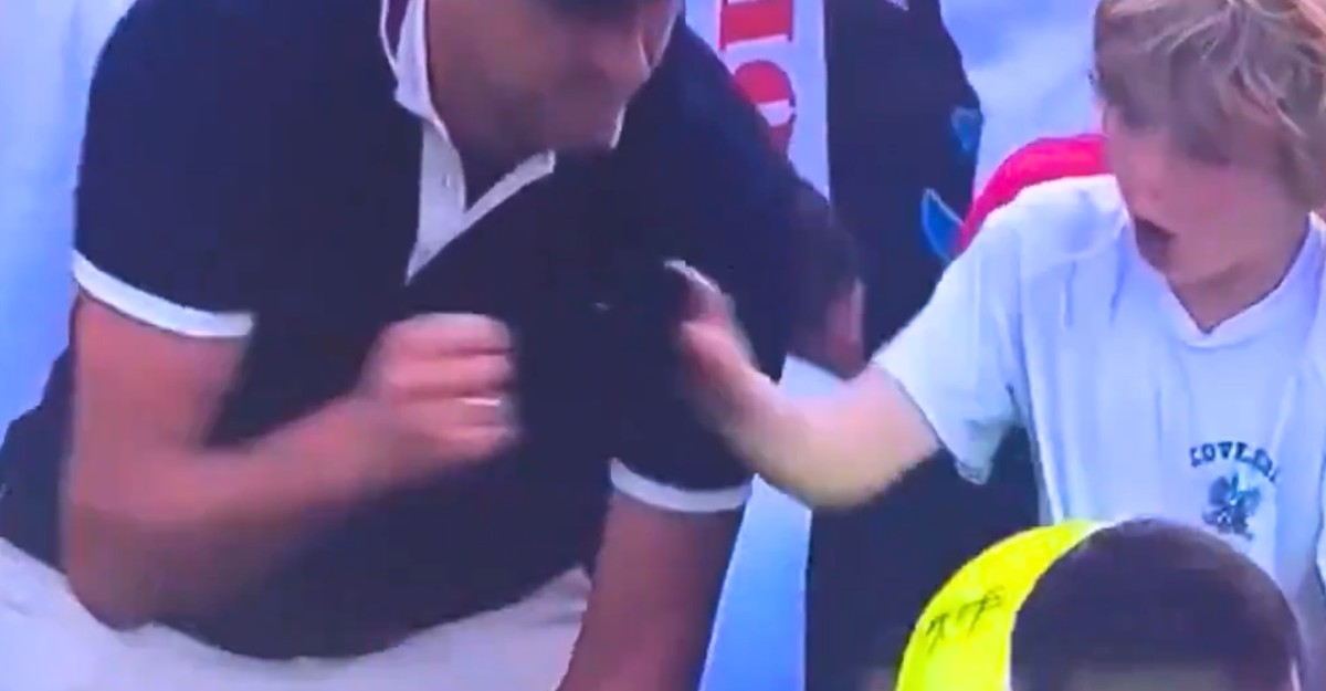 A screenshot of Piotr Szczerek, CEO of Drogbruk, taking Kamil Majchrzak's hat from a young fan at the 2025 US Open. (Photo: X)