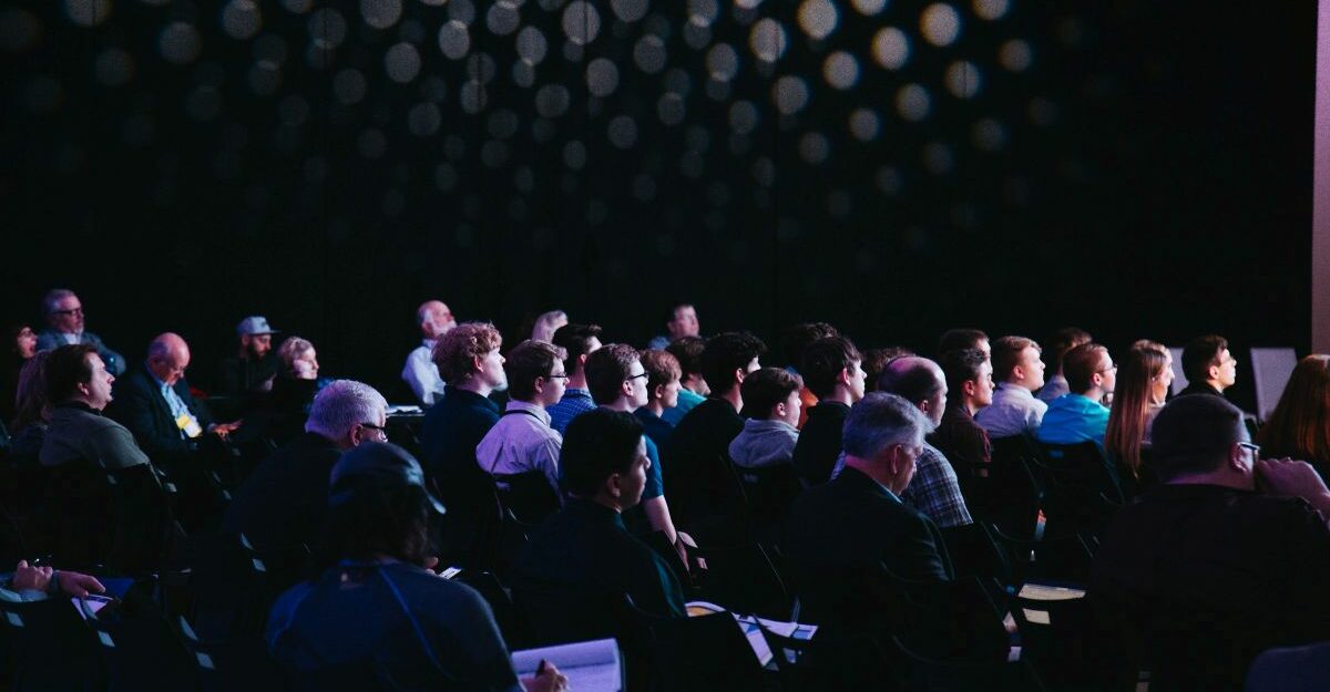 A large group of people attend an event.