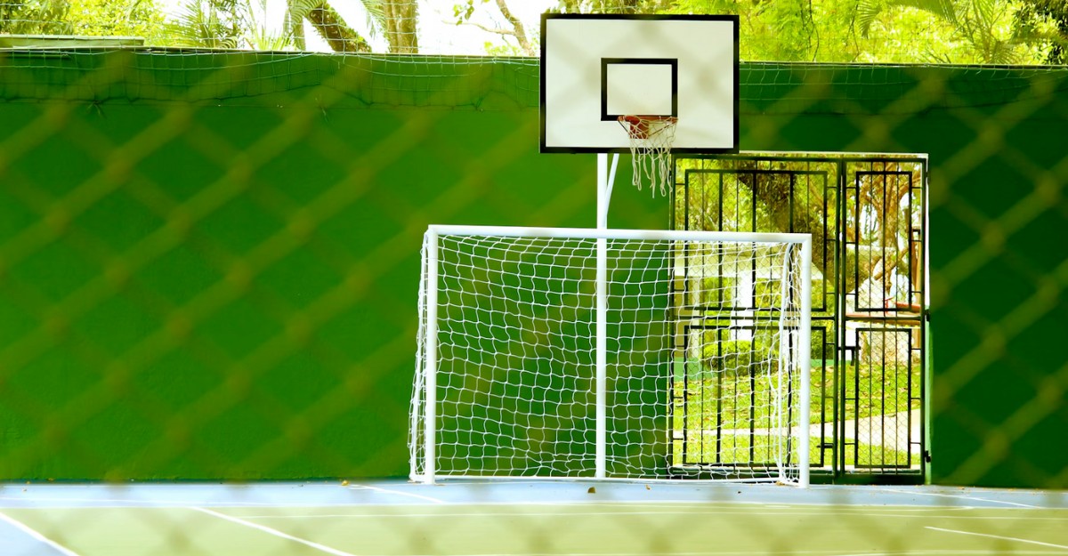 A basketball net behind a soccer net. (Photo: Daniel Dan / Unsplash)