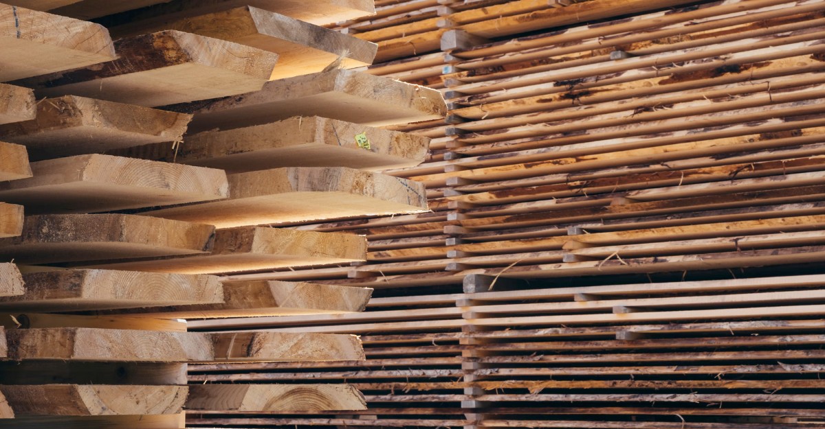 A photo of wooden planks stacked and organized. (Photo: teapowered / Unsplash)