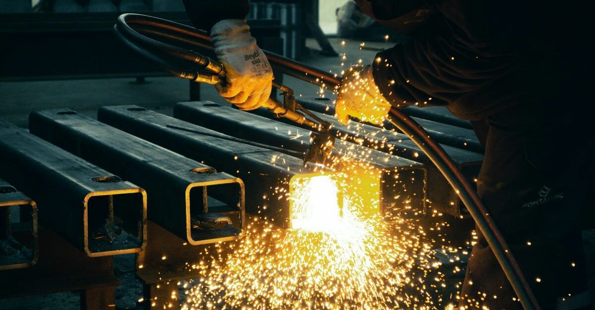 A welder at work, potentially providing services on behalf of Acden