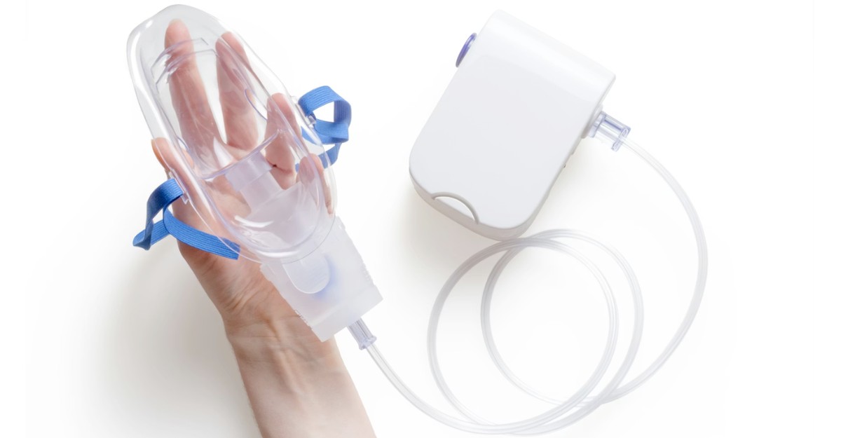 A person holding a respiratory device. (Photo: Mockup Graphics / Unsplash)